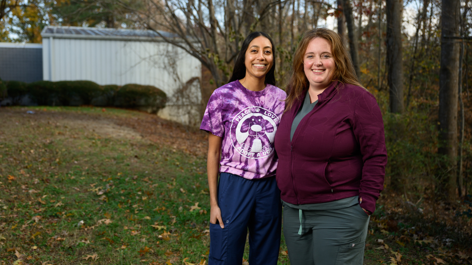 Dr. Avnee Mistry, left, and Dr. Sam Zurlinden, right, pose side-by-side on the lawn outside the Wake County Animal Center.